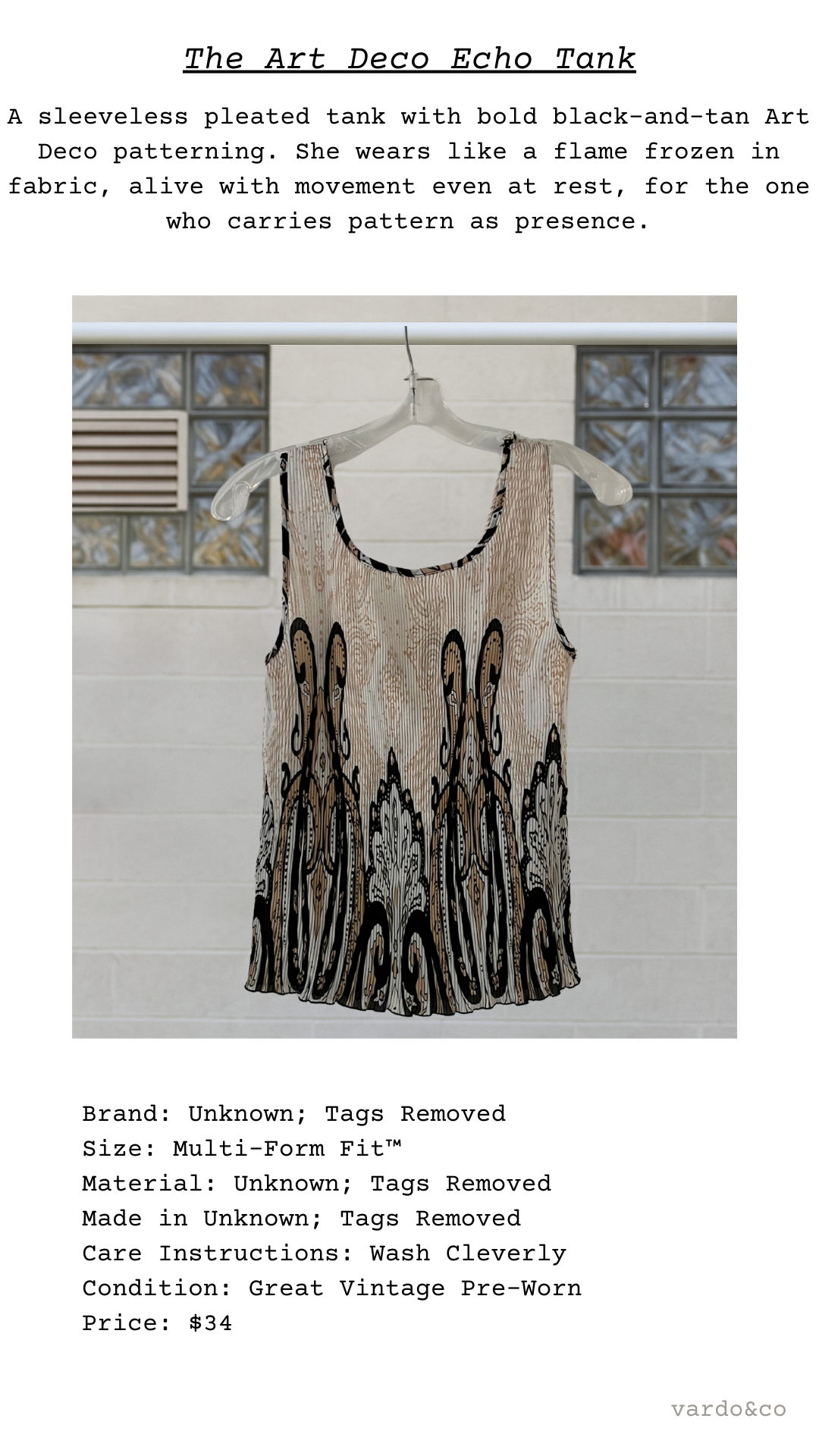 Sleeveless pleated tank with black and tan Art Deco pattern on a hanger against a white wall.
