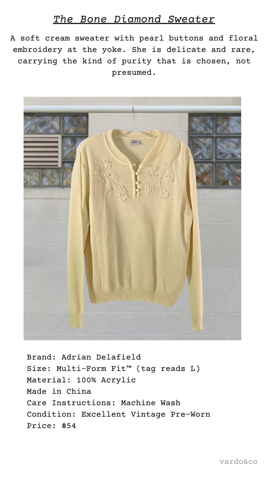 Cream sweater with pearl buttons and floral embroidery on a white background