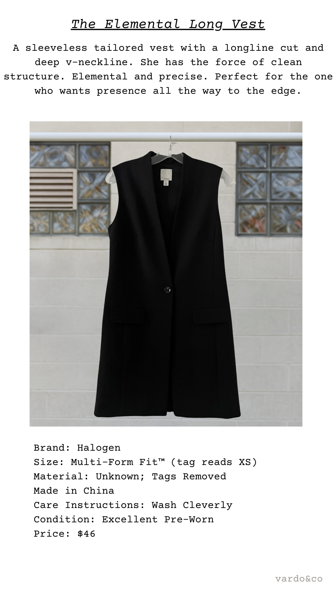 Black sleeveless vest on a hanger against a tiled wall background
