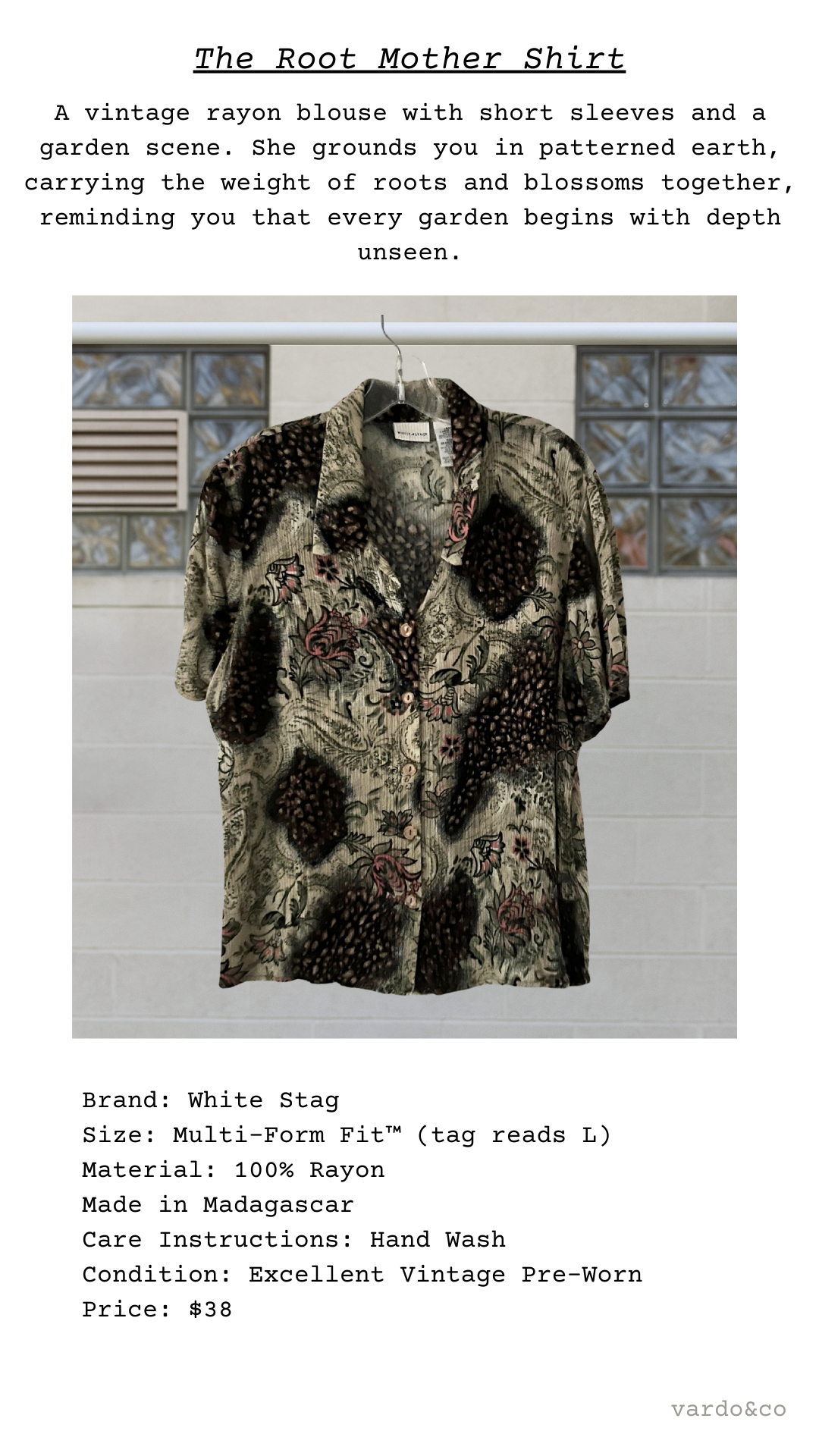 Vintage rayon blouse with short sleeves and a garden scene design, displayed against a neutral background.