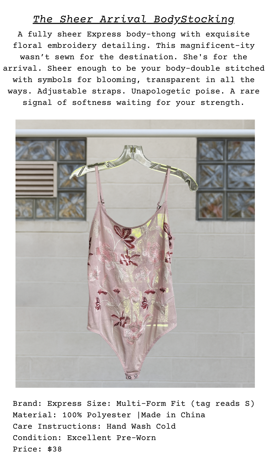 Sheer bodysuit with floral embroidery on a hanger against a neutral background