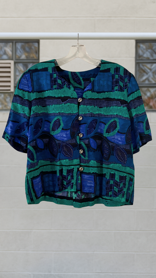 Aqua-blue tribal print blouse with decorative buttons and scooped neckline

