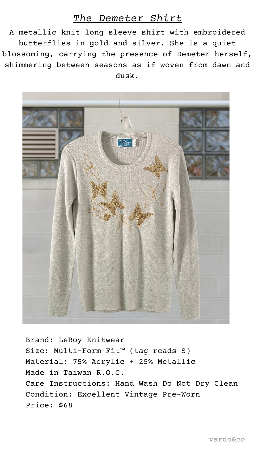 metallic long-sleeve shirt with embroidered butterflies on a hanger against a neutral background.