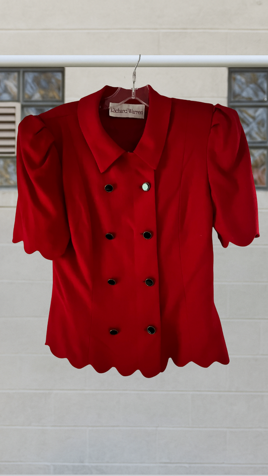 A vintage red double-breasted shirt jacket with scalloped edges, puff sleeves, and bold shoulders

