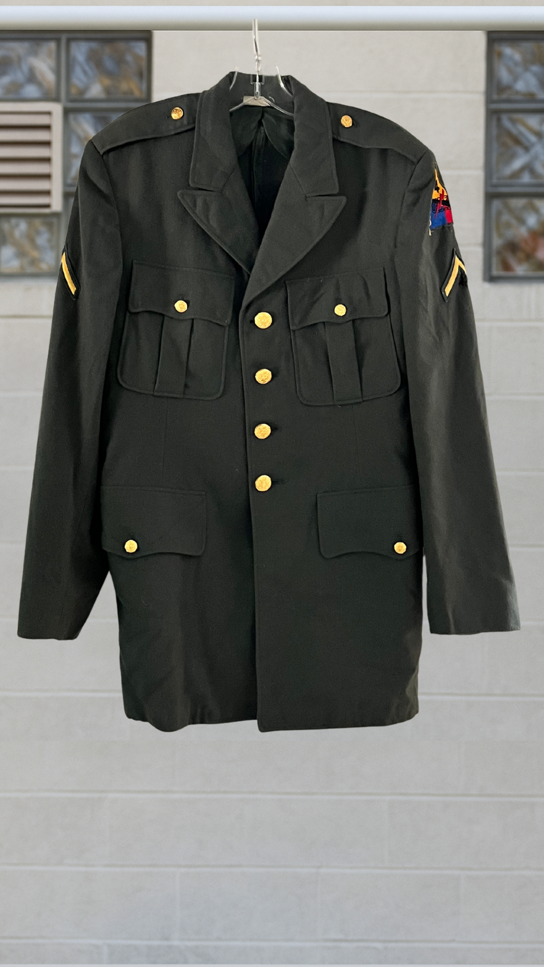 authentic army coat on a hanger against a white background