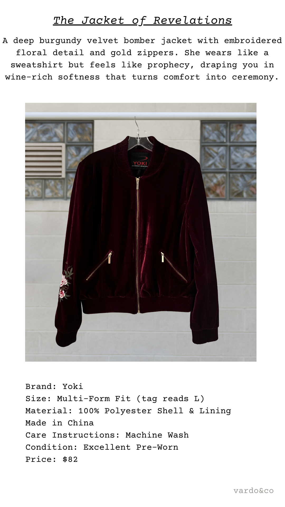 Dark burgundy velvet bomber jacket with gold zippers on a hanger against a neutral background.
