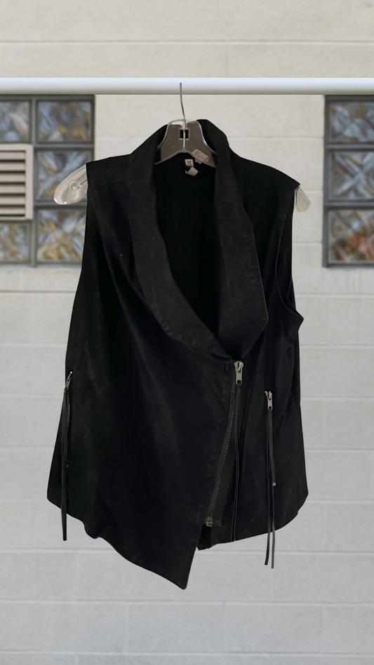 black faux leather assymetrical vest on a hanger with a white background