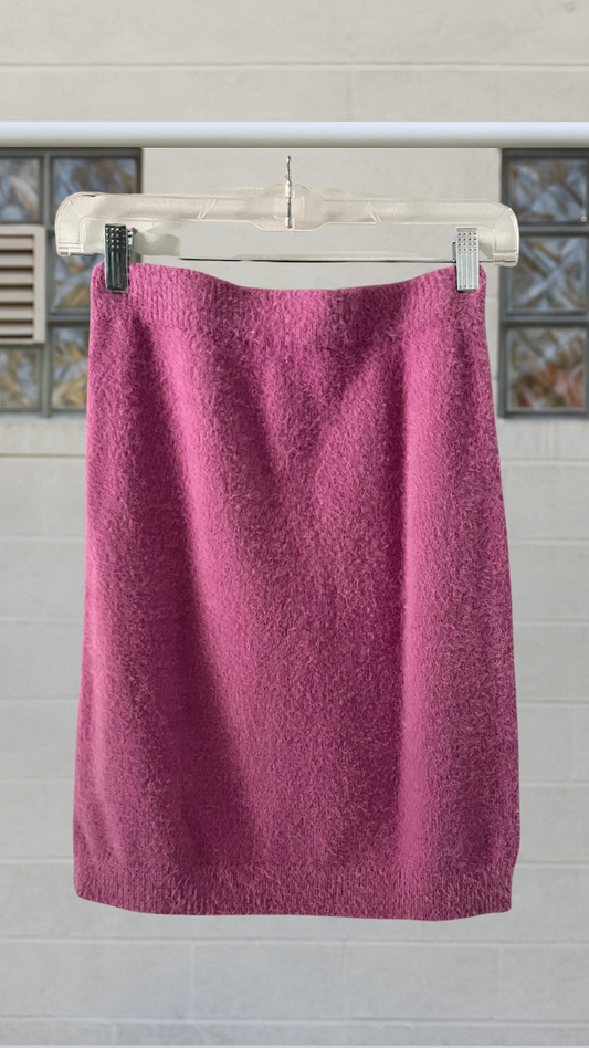 Magenta angora-textured bodycon skirt hanging on clear hanger in front of a tiled wall
