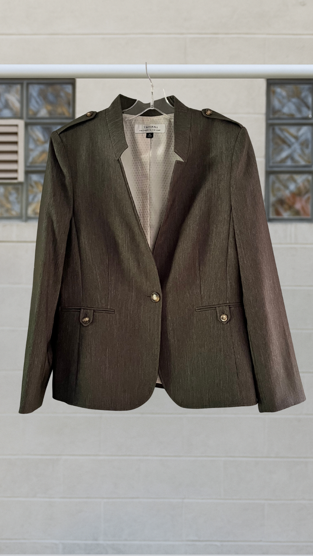 Olive military style jacket on cement background