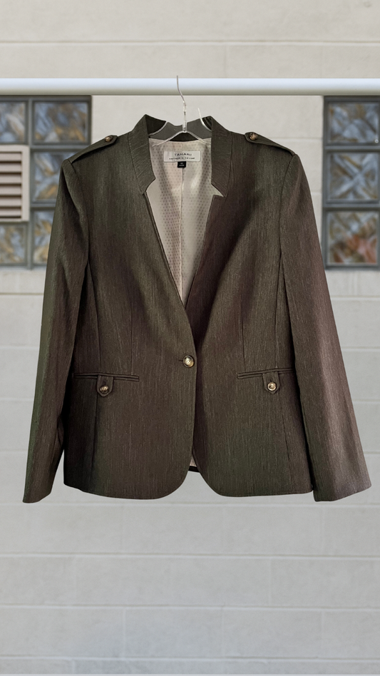 Olive military style jacket on cement background