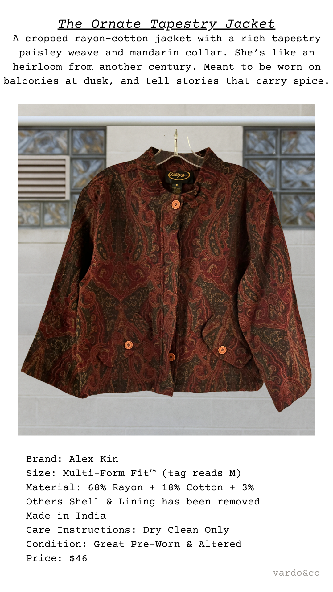 Front view of The Ornate Tapestry Jacket displayed on hanger, showing intricate paisley tapestry pattern in rust tones with orange buttons.
