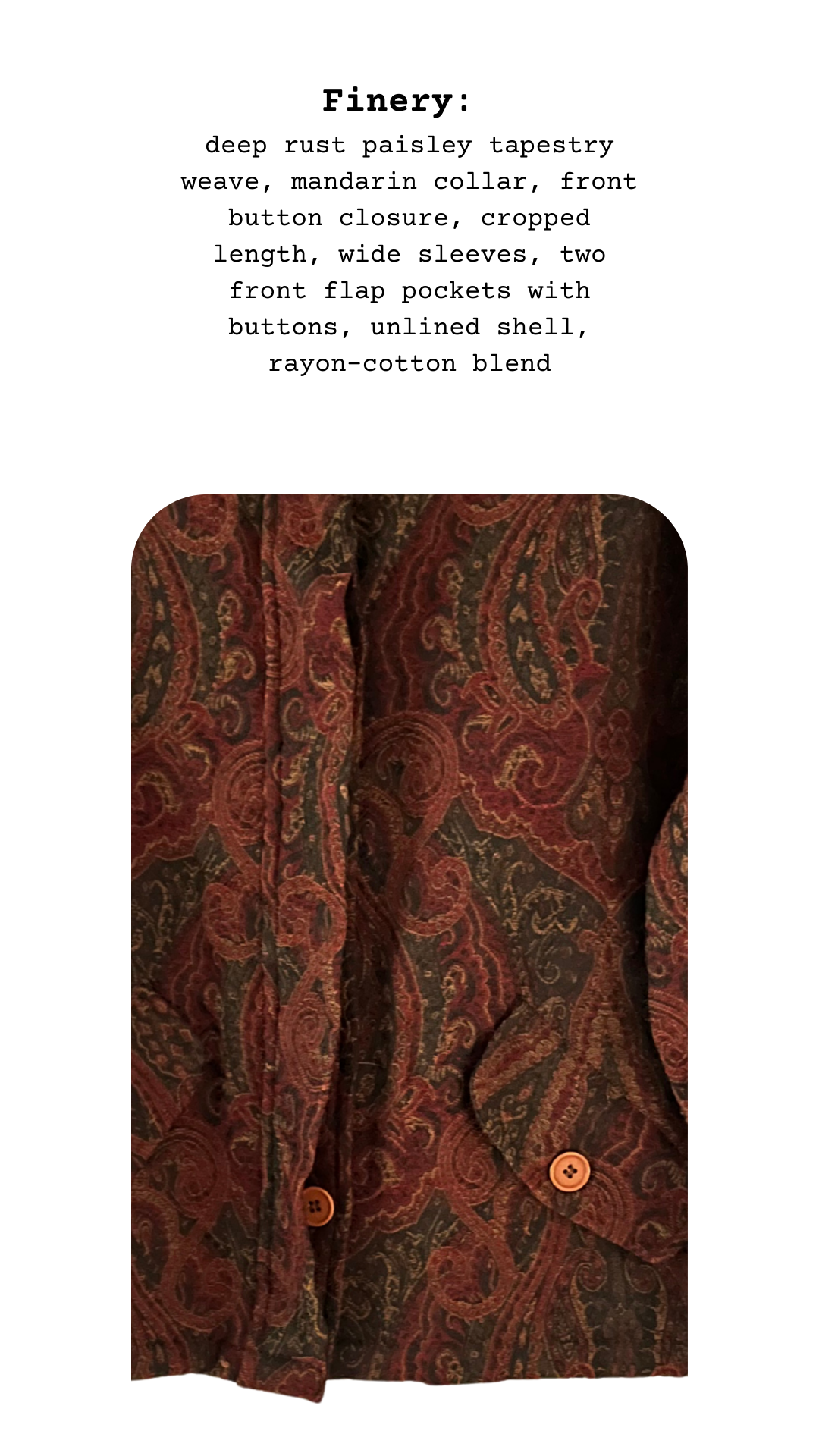 Close-up of The Ornate Tapestry Jacket fabric showing deep rust paisley tapestry weave with mandarin collar, cropped cut, and buttoned flap pockets.
