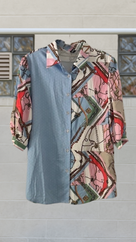 Half-and-half button‑down blouse: baby blue polka dots on one side, multicolor scarf‑print chains/ropes on the other; contrast collar and mid sleeves on hanger.
