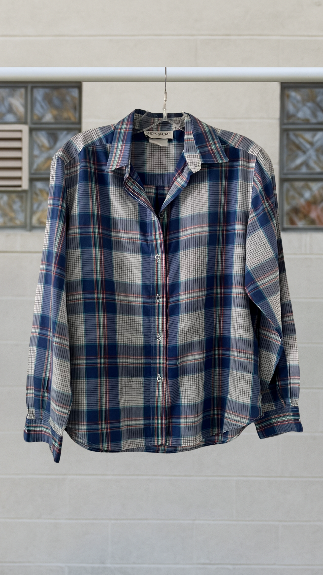 a blue plaid shirt on a white background