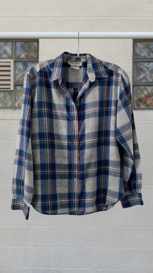 a blue plaid shirt on a white background