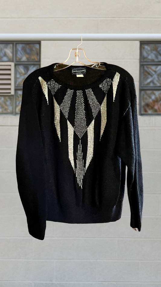 Vintage black crewneck sweater with silver V-shaped geometric graphic, metallic knit detailing.
