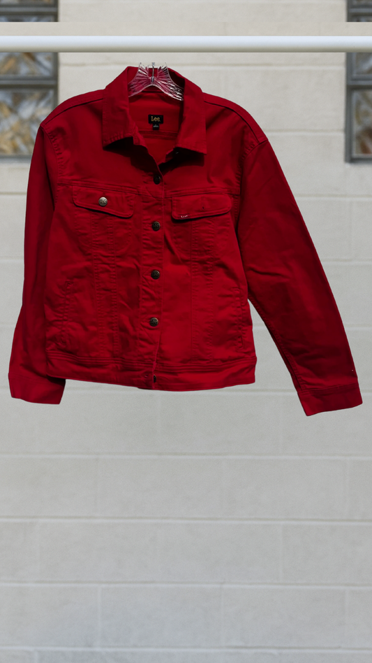 Vivid red Lee denim jacket with button-front closure, chest pockets, and classic point collar, displayed on hanger.
