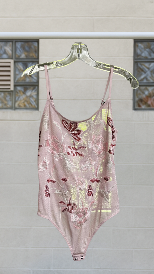 Mauve mesh bodysuit with floral embroidery in red, blush, and sage, hanging on clear hanger.