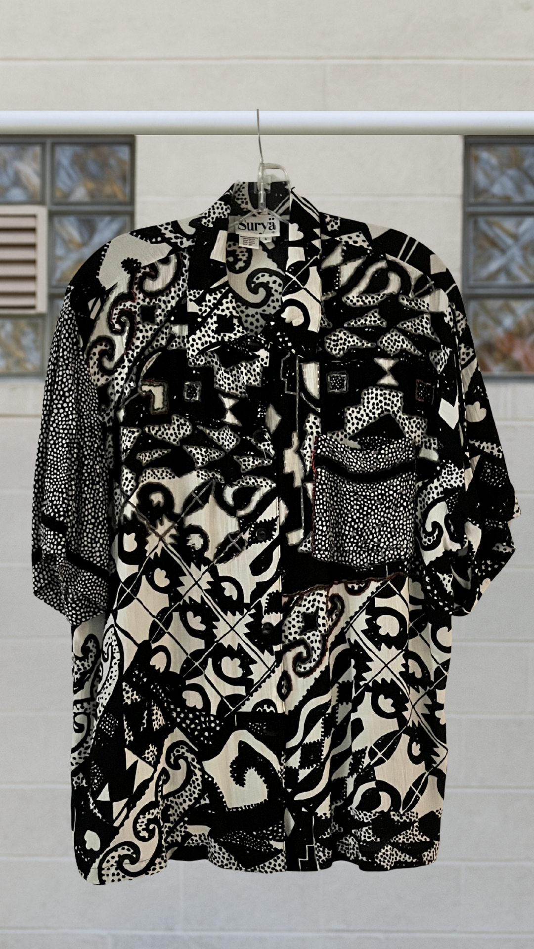 Black and white patterned shirt on a  neutral background