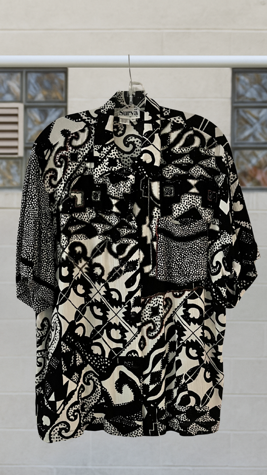Black and white patterned shirt on a  neutral background