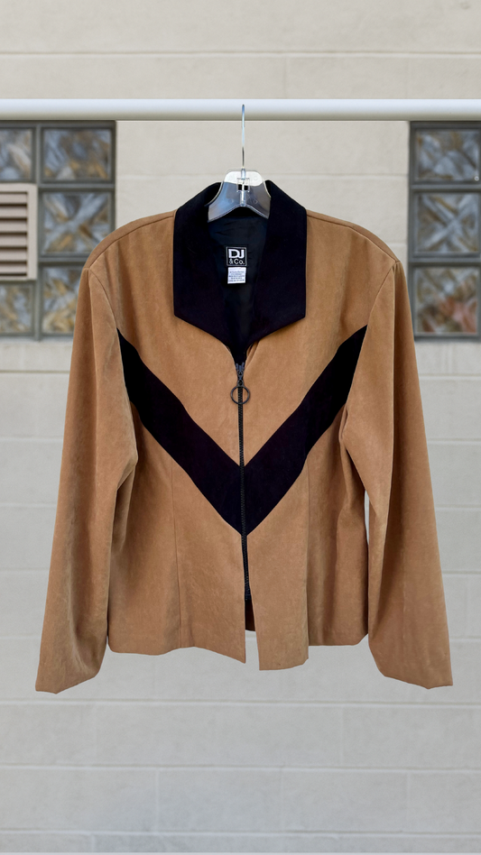 Tan and black chevron zip-up jacket with wide lapel and soft drape, vintage style hanging against a pale wall background.