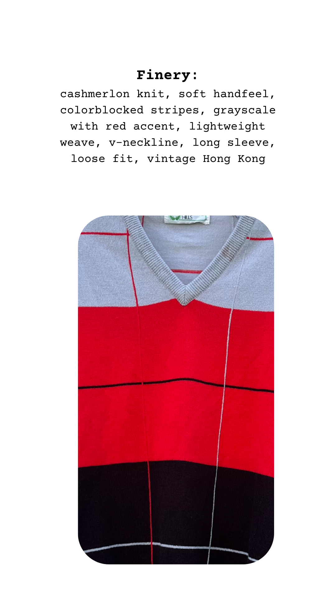 Close-up of sweater fabric showing gray v-neck trim, bold red stripe, and fine knit black base with vertical and horizontal line detailing
