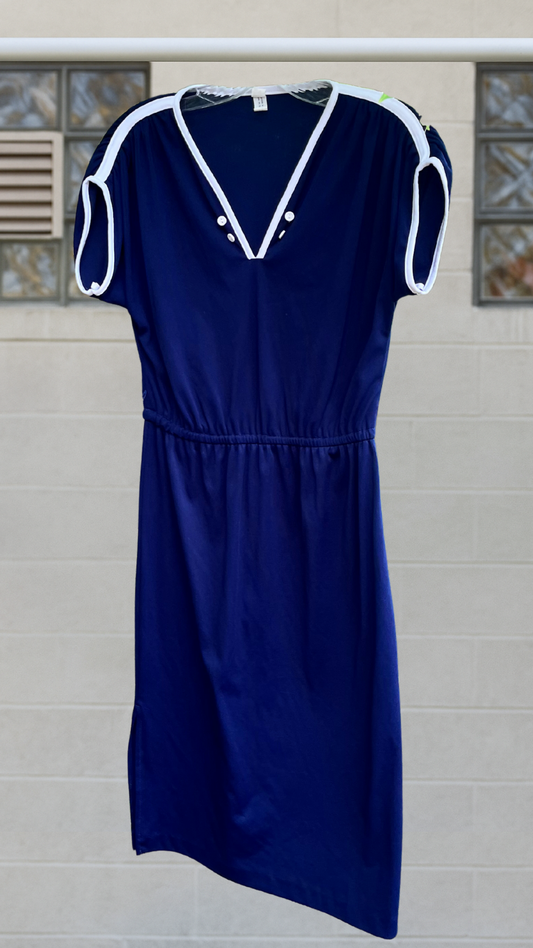 A navy blue mid-calf dress with white contrast trim, cap sleeves, and a v-neckline with button detail, displayed hanging against a light background.